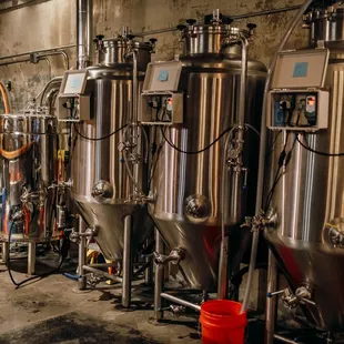 a row of stainless steel tanks