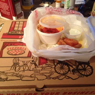 a box of pizza and a cup of sauce