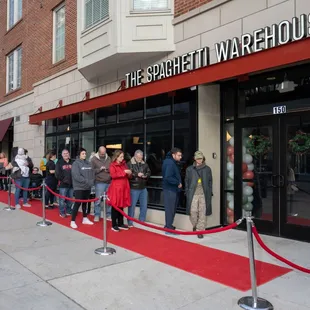 a line of people waiting outside