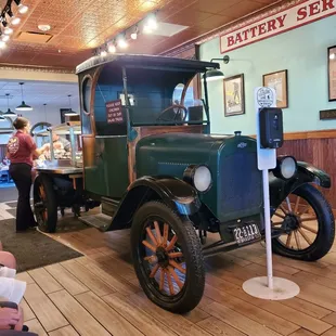 an old green truck in a restaurant