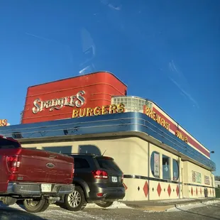 a red truck parked in front of a restaurant
