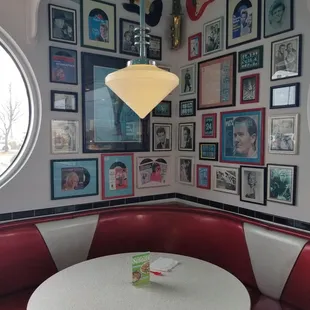 a booth with a white table and red booths