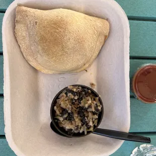 Beef empanada with black beans and rice.