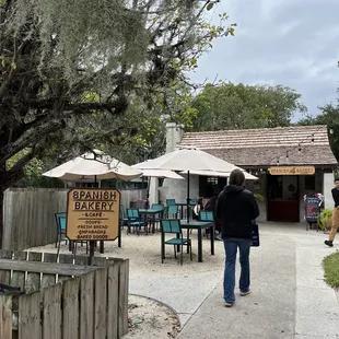 a woman walking down a sidewalk