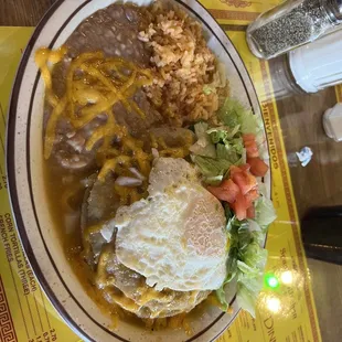 Green enchilada with egg rice beans lettuce and tomato