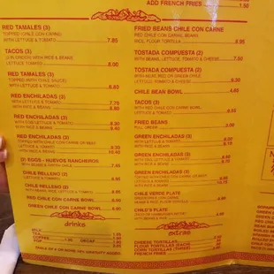 a person holding up a menu