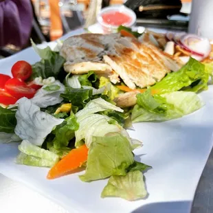 a plate of salad and chicken