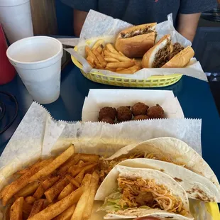 Steak Philly Cheesesteak, Homemade Hush Puppies, Mati Mati fish tacos, Cajun fries