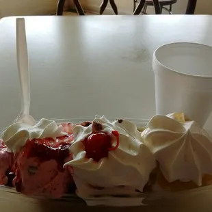 Traditional banana split: strawberry, chocolate, and pineapple on strawberry, chocolate, and vanilla on bananas + whipped cream + cherry!