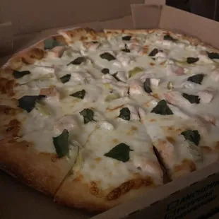 Medium pizza with housemade white sauce, chicken, artichoke, and basil