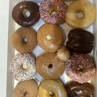 Dozen donuts : chocolate, cinnamon sugar, sprinkle glaze, raspberry filled, vanilla cream, chocolate buttermilk, &amp; glazed donuts