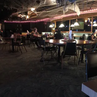 The SR is a dark bar that serves food.