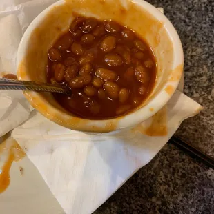 a bowl of baked beans on a plate