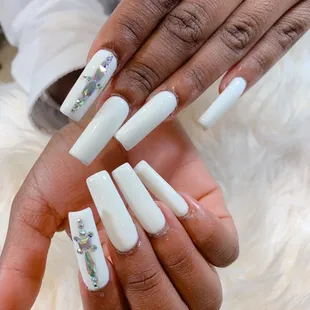 White acrylic Nails with diamonds design.
