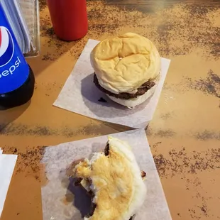 The burgers are served on small pieces of paper when you eat at the bar, baskets are used for the tables. Very cool place.