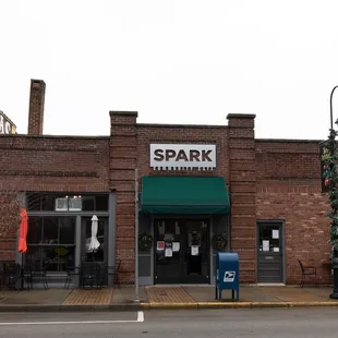 a brick building with a green awning