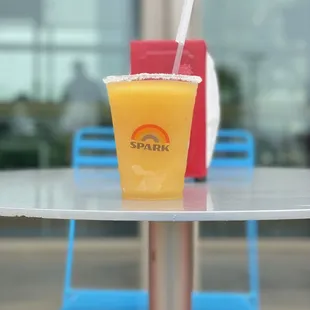 a drink in a plastic cup on a table