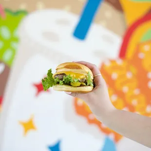 a person holding a sandwich in their hand