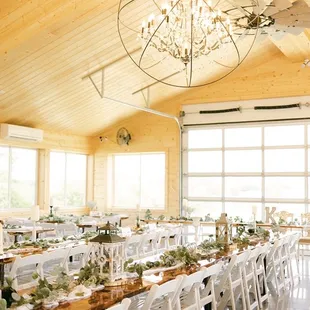 Patio barn with wrap around windows and glass garage door looking out o; the pond.
