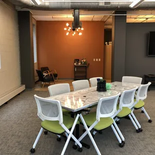 A view of the Hideout that shows a breakout space along the orange wall.