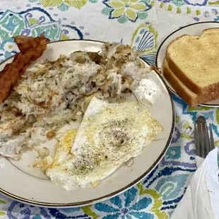 Two eggs over easy, bacon and potato toast