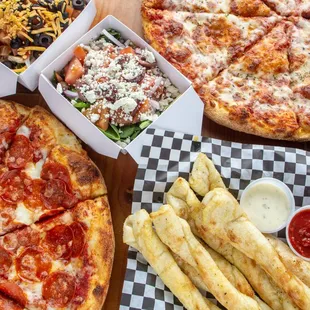 a pizza, fries and salad