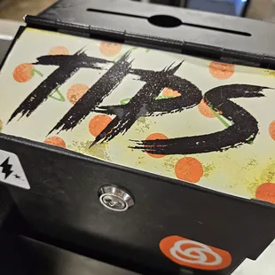 a pizza box with the word tips painted on it