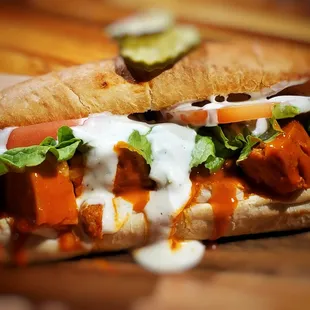 a hot dog with lettuce, tomato, and cheese