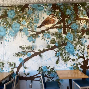 a mural of birds and flowers