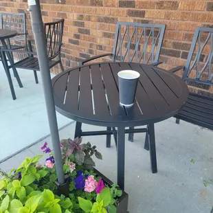 Several outdoor tables with umbrellas and plants
