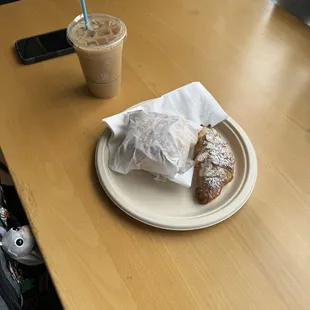 Iced latte, breakfast sandwich, almond croissant