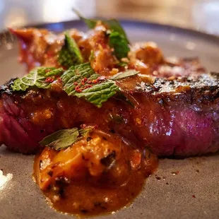 Kalbi rib eye, chili lobster gratin, thai basil, garlic bread crumb
