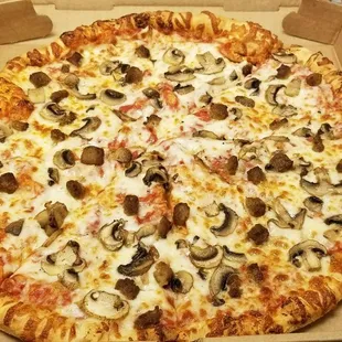 Large mushroom and sausage pizza.