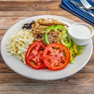 Chicken Salad: lettuce, marinated chicken breast, tomatoes, peppers, mushrooms, olives, Danish cheese.