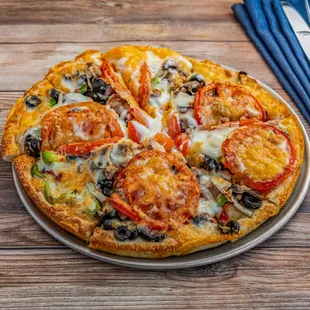 Veggie Pizza (#26): Mushrooms, green peppers, olives, onions  and sliced tomatoes.