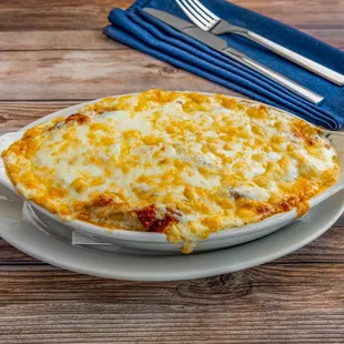 Baked Lasagna: our twist on classic lasagna. Pasta with meat sauce baked to perfection. Served with garlic bread and salad or soup.