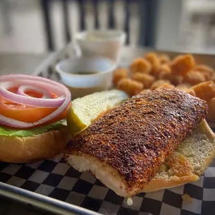 a fish sandwich and onion rings