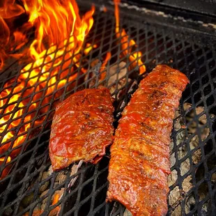 two steaks on a grill