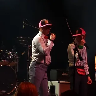 a group of men singing on stage