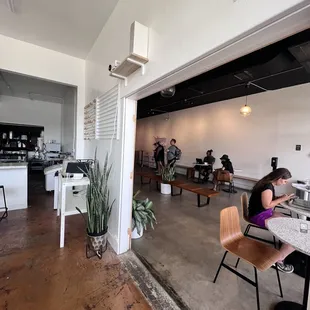 a woman sitting at a table in a coffee shop