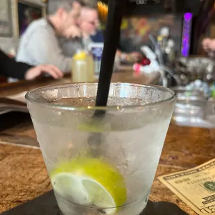 a glass of lemonade with a straw