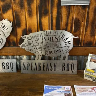 a table with a sign and a pig
