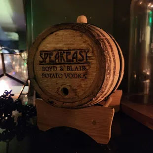 a wooden barrel with the words speakeasy on it