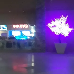 This is front of casino and bar is outside with music being played and glass doors are open