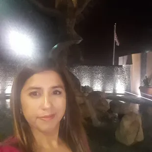 Enjoying the sound of the water coming down the rock wall