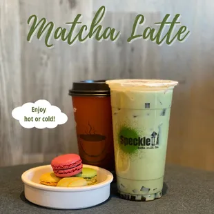 a cup of matcha latte and a plate of macarons