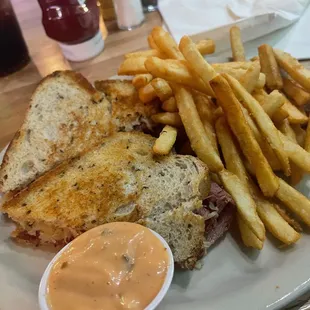 Reuben with side of fries, dipping sauce
