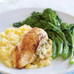 a plate of chicken, mashed potatoes and broccoli