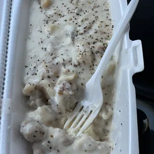 a chicken and gravy dish in a styrofoam container