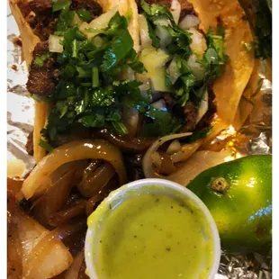 Beef fajita tacos on corn tortillas.